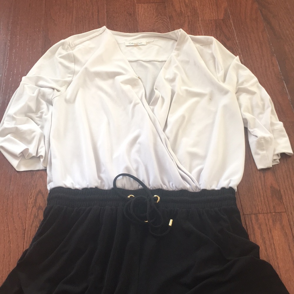 White and black shorts romper with wrap top.